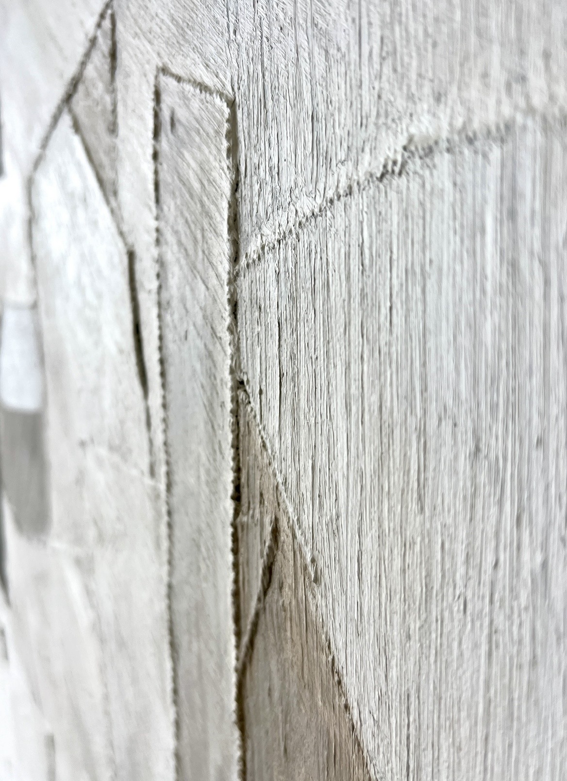 Close detail of layered white canvas and painted collage edges